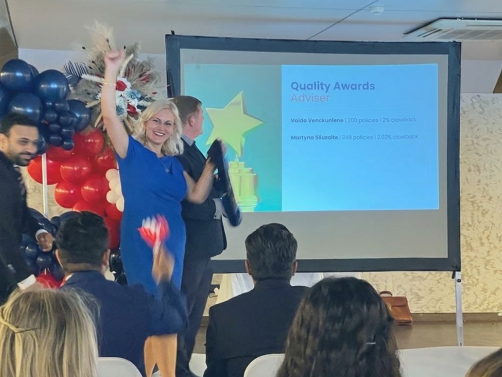 Vaida V. Stone receiving a Quality Awards Adviser recognition at a financial services industry event.